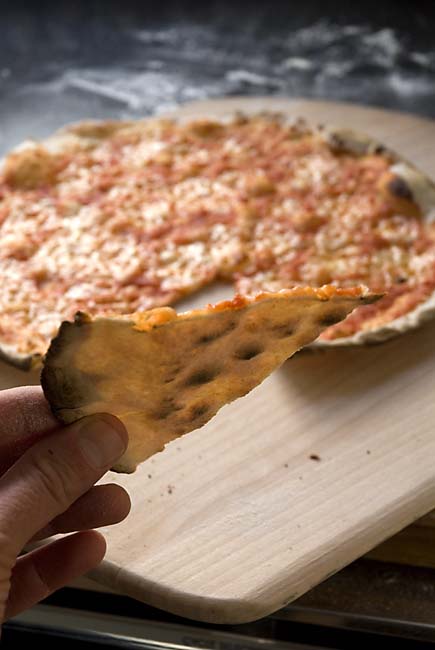 Cracker-crust pizza is so thin the light shines through it