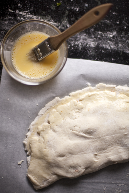 Gluten-Free Calzone before baking and a bowl of egg wash | Artisan Bread in Five Minutes a Day