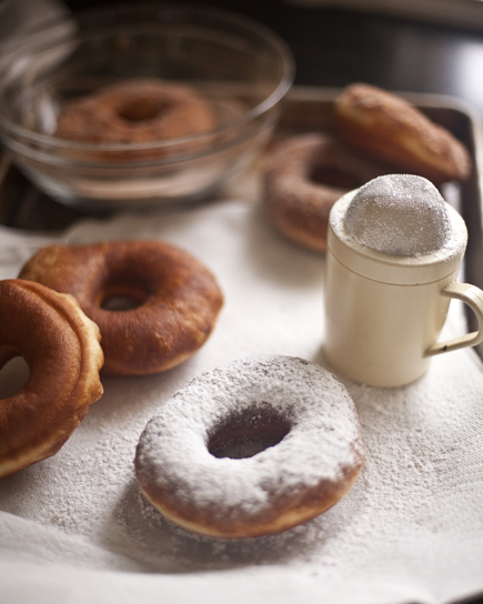 Adding powdered sugar to fresh, homemade doughnuts | Artisan Bread in Five Minutes a Day