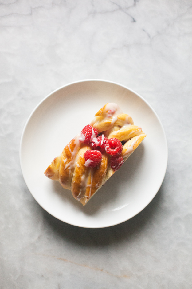 Slice of Raspberry Cream Cheese Brioche Braid with Powdered Sugar Drizzle